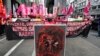 Women activists display a sign in solidarity with protests in Myanmar as they march near the Malacanang presidential palace to mark International Women's Day on Monday March 8, 2021, in Manila, Philippines. 