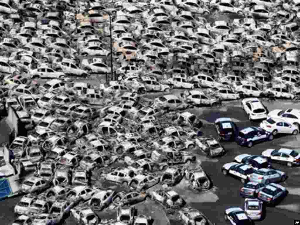 In this photo taken Friday, March 11, 2011, an aerial view shows vehicles washed away by an earthquake triggered tsunami in Hitachinaka, Ibaraki prefecture, Japan