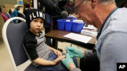 A nurse draws a blood sample from a student at Eisenhower Elementary School in Flint, Michigan, Jan. 26, 2016. Students at the school were being tested for lead after the metal was found in the city's drinking water.