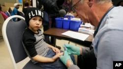 A nurse draws a blood sample from a student at Eisenhower Elementary School in Flint, Michigan, Jan. 26, 2016. Students at the school were being tested for lead after the metal was found in the city's drinking water.