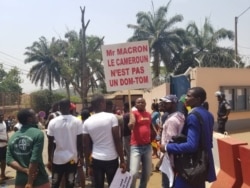 Youths protest against French President Emmanuel Macron's declarations over how Cameroon is handling the conflict in its English-speaking regions, outside the French embassy in Yaounde, Feb. 24, 2020. (Moki Edwin Kindzeka/VOA)