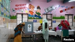 People vote at a polling station during the state assembly election in New Delhi, India, Feb. 5, 2025. 