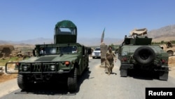 Afghan National Army soldiers patrol the area near a checkpoint recaptured from the Taliban, in the Alishing district of Laghman province, Afghanistan, July 8, 2021.