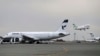 FILE - In this Feb. 7, 2016, photo, an Iranian Mahan Air passenger plane takes off as a plane of Iran's national air carrier Iran Air, left, is parked at Mehrabad airport in Tehran, Iran.