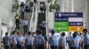 Police officers gather as they wait for the arrival of former Philippine president Rodrigo Duterte at Ninoy Aquino International Airport in Pasay, metro Manila on March 11, 2025.