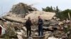 Men check the site of an Israeli air strike in the southern Lebanese village of Jibshit on Feb. 27, 2024.