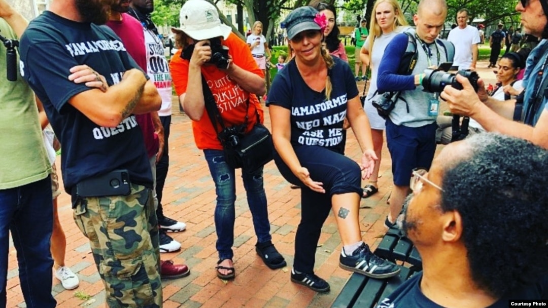 FILE - Shannon Martinez shows the Celtic cross tattoo on her leg to protesters at the “Unite the Right” rally in Washington, D.C., Aug. 12, 2018. (Photo courtesy of Shannon Martinez)