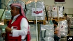 Qatari Red Crescent employees prepare assistance packages to be sent for earthquake hit areas of Turkey, at Al-Udeid Air Base in Doha, Qatar, Feb. 7, 2023.