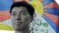In this March 20, 2011 file photo, newly-elected Tibetan prime minister Lobsang Sangay talks to the Associated Press with a Tibetan flag in the background in Dharmsala, India.