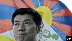 In this March 20, 2011 file photo, newly-elected Tibetan prime minister Lobsang Sangay talks to the Associated Press with a Tibetan flag in the background in Dharmsala, India.