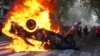 A protester burns a police car during a demonstration by soccer fans and retirees demanding higher pensions and opposing austerity measures implemented by Javier Milei's government in Buenos Aires, Argentina, March 12, 2025. 