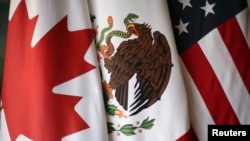 Flags are pictured during the fifth round of NAFTA talks involving the United States, Mexico and Canada, in Mexico City, Nov. 19, 2017. 