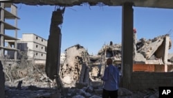 FILE - A man checks his damaged house at the site of an Israeli airstrike in Baalbek, east Lebanon, Oct. 7, 2024.