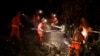 A California Department of Corrections hand crew works containment lines ahead of the Palisades Fire Jan. 14, 2025, in Santa Monica, Calif. 