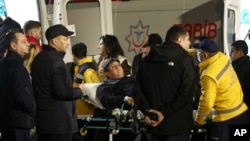 Rescuers transport wounded passengers from a medical plane upon their arrival at the Heydar Aliyev International Airport outside Baku, Azerbaijan, on Dec. 26, 2024, after an Azerbaijan Airlines plane crashed near the Kazakhstani city of Aktau.