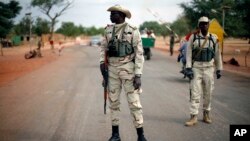 Malian soldiers man a checkpoint on the Gao road outside Sevare, some 620 kilometers (385 miles) north of Mali's capital Bamako, Jan. 27, 2013.