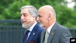 FILE - Afghanistan's President Ashraf Ghani, right, and Chief Executive Abdullah Abdullah arrive for sessions of the second day of the NATO Summit, in Warsaw, Poland, July 9, 2016.