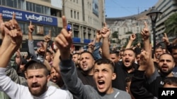 FILE - Supporters of the Palestinian group Hamas gesture as they chant slogans during a protest in support of Gaza in Nablus city in the occupied West Bank on October 18, 2023.