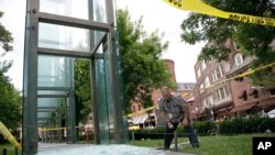 Bill Satterlund, facilities manager for Combined Jewish Philanthropies of Boston, begins to pick up broken glass from one of the Holocaust Memorial's glass panels shattered with a rock thrown shortly before 2 a.m., June 28, 2017. The memorial is designed around six luminous glass towers, which symbolize the 6 million Jews killed in the Holocaust, the names of the six main death camps, and the six years during which Adolf Hitler's "Final Solution" took place from 1939 to 1945.