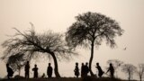 Afghan refugee boys play in a field on the outskirts of Islamabad, Pakistan.