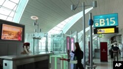 A woman enters the face and iris-recognition gate to board a plane, during a media tour at Dubai Airport, in the United Arab Emirates, March 7, 2021. 