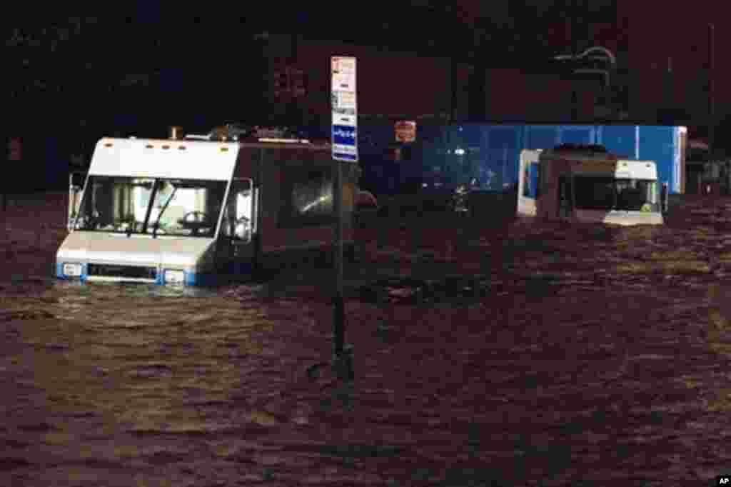 Consolidated Edision trucks are submerged on 14th Street near the ConEd power plant, October 29, 2012, in New York. Sandy knocked out power to at least 3.1 million people.