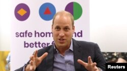 Britain's Prince William, Duke of Cambridge speaks to former and current service users during a visit to the Albert Kennedy Trust in London, Britain, June 26, 2019. 
