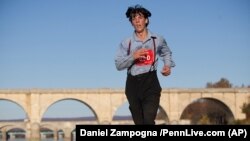 FILE - Leroy Stolzfus of Gordonville, Pa., runs in the 2015 Harrisburg Marathon in Harrisburg, Pa. Photo taken Nov. 8, 2015. 