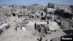 A Palestinian walks past the rubble of houses destroyed by Israeli strikes, amid Israel-Hamas conflict, in Khan Younis in the southern Gaza Strip, Sept. 4, 2024. 