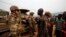 FILE - Angry young men complain to French soldiers in patrol in the pro-Christian area of Bangui, Feb. 15, 2014.