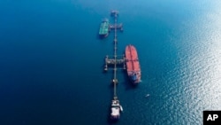 FILE - An aerial photo shows oil tankers loading crude oil at Iraq's al-Basra offshore terminal in Basra, Iraq, Dec. 27, 2020. 
