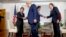 FILE - President Donald Trump shakes hands with Japanese Economy Minister Toshimitsu Motegi and Japanese PM Shinzo Abe greets U.S. Trade Representative Robert Lighthizer after announcement of a preliminary trade pact, in Biarritz, France, Aug. 25, 2019.