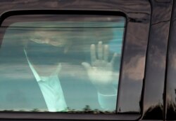 FILE PHOTO: FILE PHOTO: U.S. President Donald Trump waves to supporters outside of Walter Reed National Military Medical Center