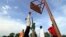 FILE - A basketball team plays a game before the arrival of the body of Sudan-born NBA star Manute Bol in the town of Turalei in Warap state, southern Sudan.