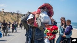 FILE—Displaced Palestinians trying to walk back from central Gaza Strip to northern Gaza Strip, April 14, 2024