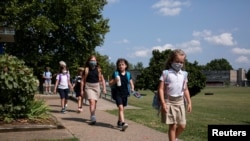 Los estudiantes abandonan la escuela primaria St Matthew's al final de su primer día de la clase, en Louisville, Kentucky, EE. UU., el 11 de agosto de 2021..