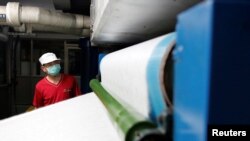 Staff member works inside a non woven filter fabric factory