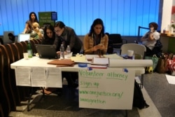 FILE - Volunteer immigration attorneys organize to help as people grappling with President Donald Trump's executive order travel ban, at Los Angeles International Airport, Jan. 31, 2017.