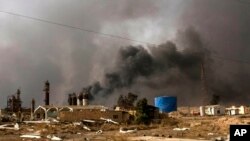 Oil wells on the edge of Qaraya Sunday August 28, 2016 burn days after the key town south of was retaken from the Islamic State group by Iraqi ground forces backed by U.S.-led coalition airpower.