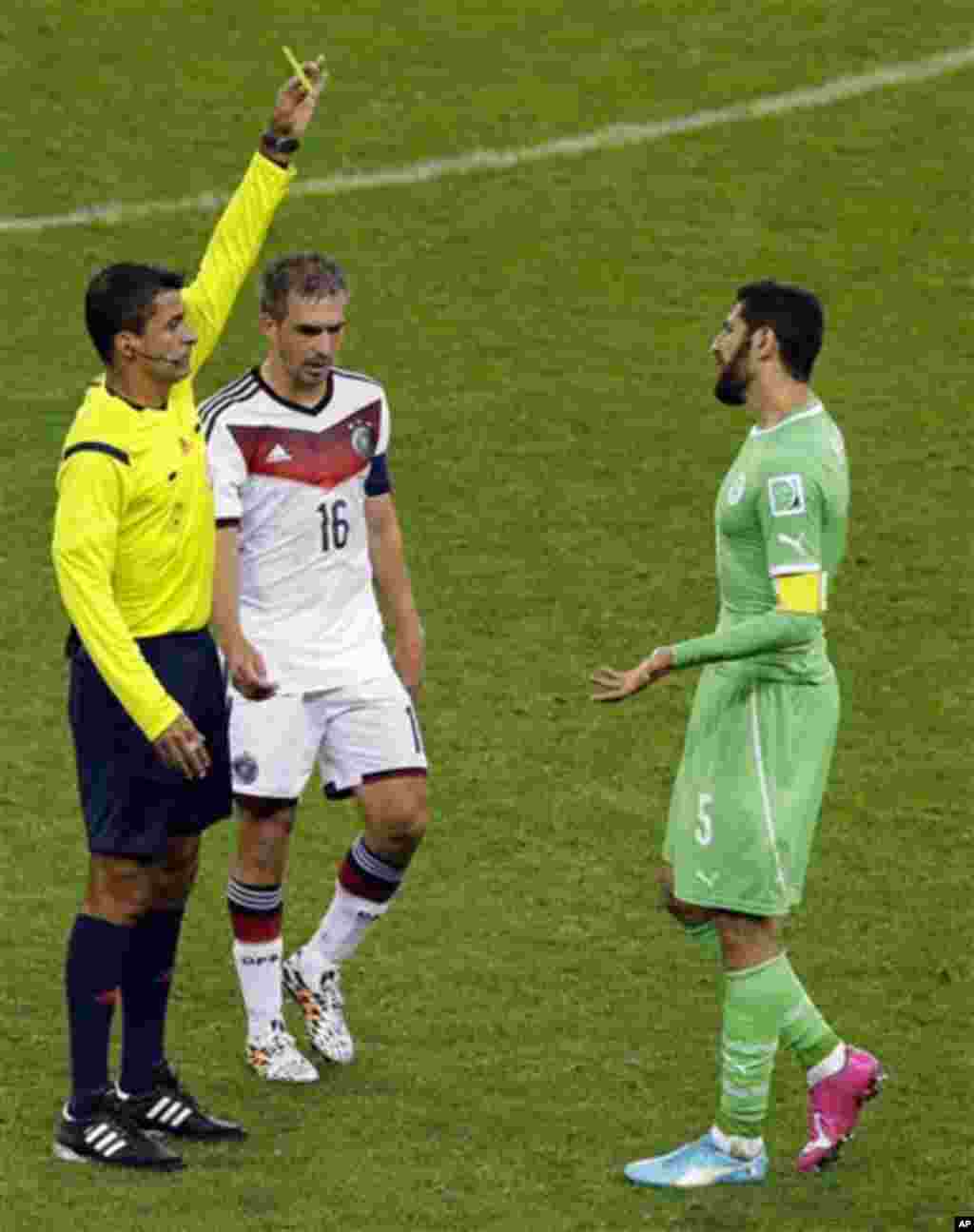 Algeria's Rafik Halliche, right, is booked by referee Sandro Ricci from Brazil during the World Cup round of 16 soccer match between Germany and Algeria at the Estadio Beira-Rio in Porto Alegre, Brazil, Monday, June 30, 2014. Between them is Germany's Phi