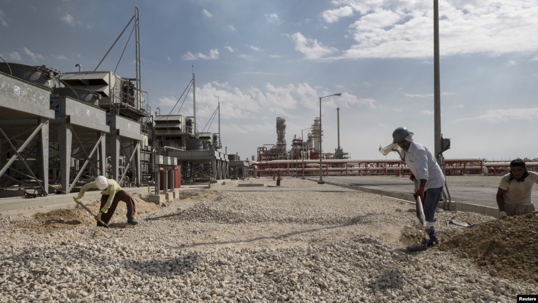 Iranian laborers work at a unit of South Pars gas field in Asalouyeh Seaport, north of Persian Gulf, Iran, Nov. 19, 2015. China's state-owned CNPC energy company now owns 80 percent of the project's share after Total dropped out because of U.S. sanctions.