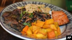 The sampler plate at the American Indian museum contains grilled bison and salmon, roasted butternut squash, wild rice salad, and Peruvian lima bean salad.