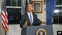 President Barack Obama poses for photographers in the Blue Room at the White House in Washington after he spoke regarding the budget and the averted government shutdown after a deal was made between Republican and Democrat lawmakers, April 8, 2011