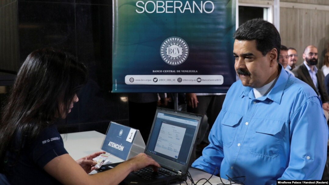 Venezuela's President Nicolas Maduro participates in the process of buying a savings certificate in gold at Venezuela's Central Bank in Caracas, Sept. 3, 2018.