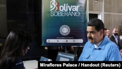 FILE - Venezuela's President Nicolas Maduro participates in the process of buying a savings certificate in gold at Venezuela's Central Bank in Caracas, Sept. 3, 2018.