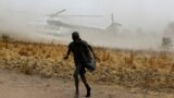 A boy moves away as a United Nations World Food Programme (WFP) helicopter lands in Rubkuai village, Unity State, northern South Sudan, February 18, 2017.