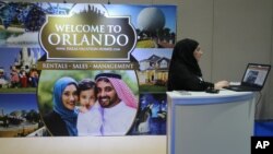 An exhibitor works at an American Halal Vacation Homes booth at The World Halal Travel Summit & Exhibition in Abu Dhabi, United Arab Emirates, October 19, 2015.