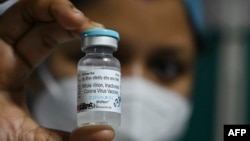 A health staff shows a vial of 'India's first indigenous Covid-19 vaccine, "Covaxin" at the Kolkata Medical College and Hospital in Kolkata on February 3, 2021. (Photo by DIBYANGSHU SARKAR / AFP)
