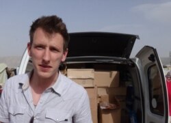 FILE - Abdul Rahman (Peter) Kassig, an American aid worker, makes a food delivery to refugees in Lebanon’s Bekaa Valley, May 2013. (Courtesy of Kassig family)