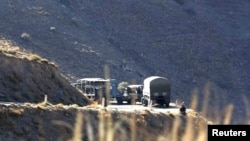 Algerian military troops are pictured at a mountain near the village of Ait Ouabane, where a Frenchman was kidnapped by militants on Sunday, southeast of Algiers, Algeria, Sept. 23, 2014.